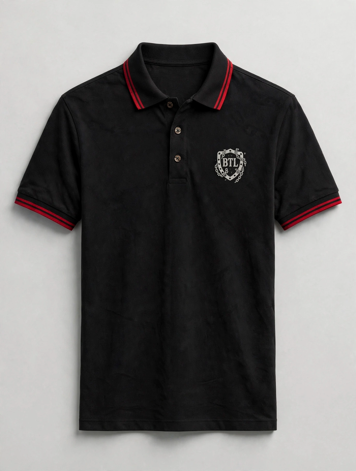 Black men’s Built to Last polo with a small red BTL shield and red collar tipping