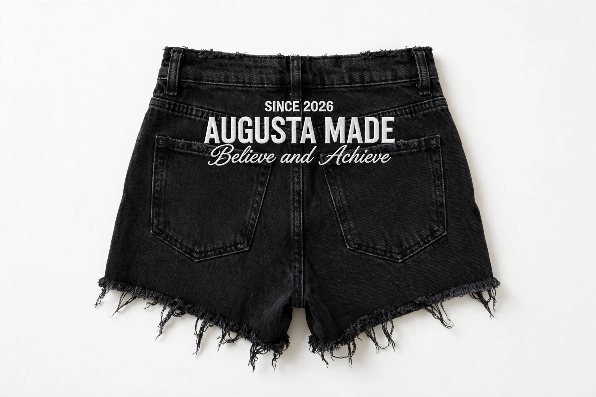 Back of black cutoff denim daisy dukes embroidered with Since 2026, Augusta Made, Believe and Achieve