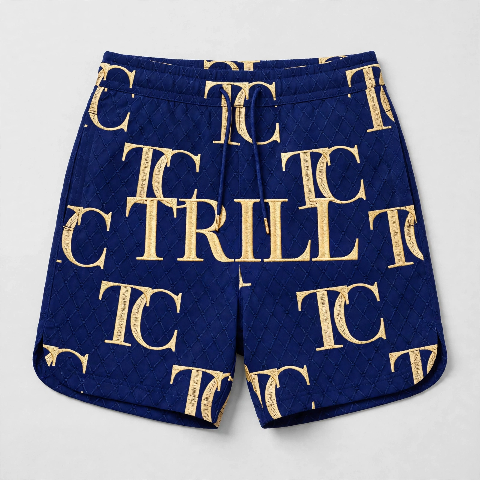 Blue quilted women’s shorts with gold TC monogram print and TRILL lettering across the front
